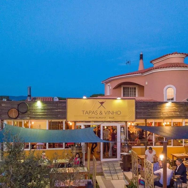 Illuminated exterior of Simply Tapas & Vinho in Almancil