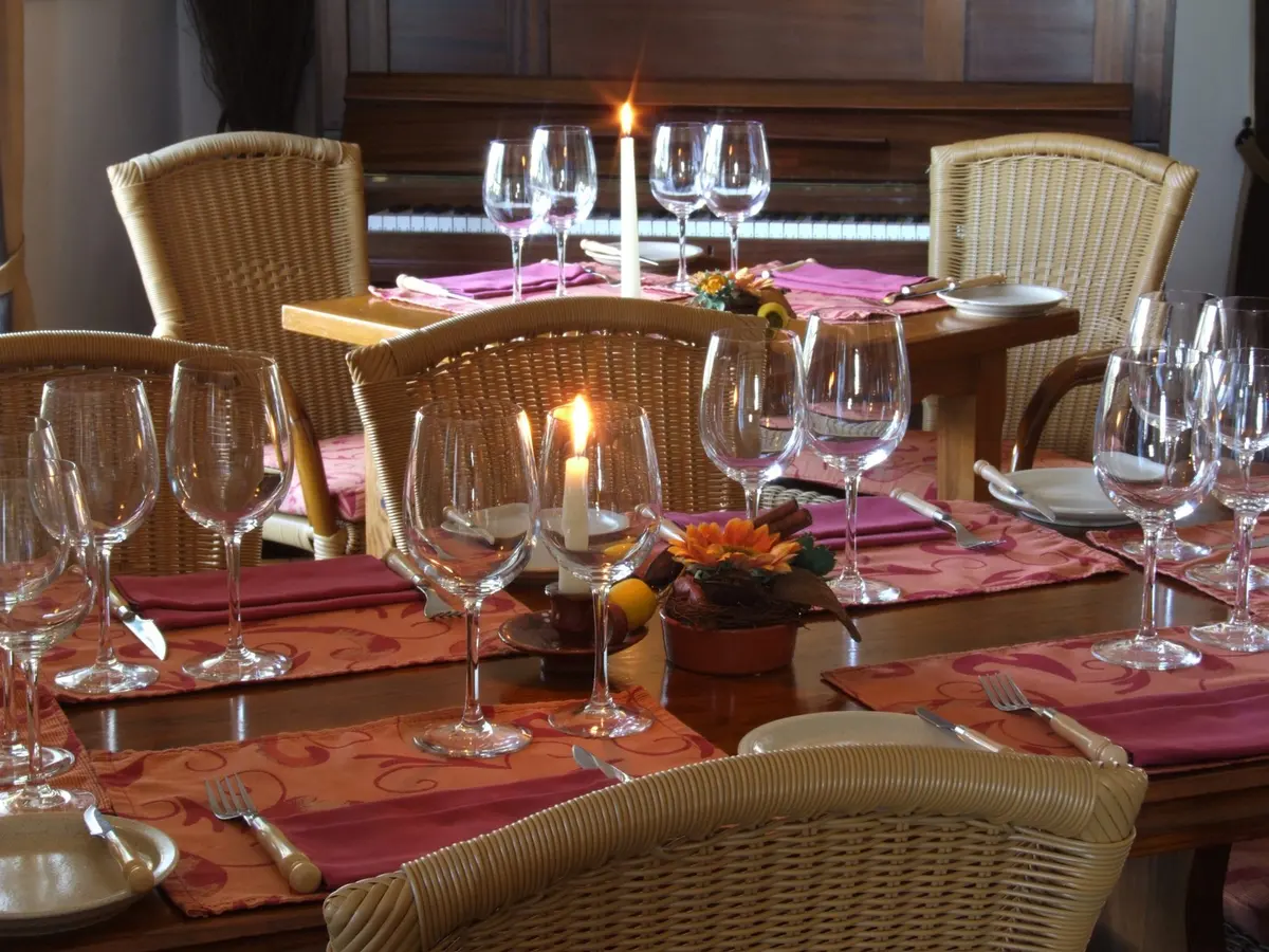 Candlelit tables, wine glasses and wicker chairs in Vila Velha restaurant