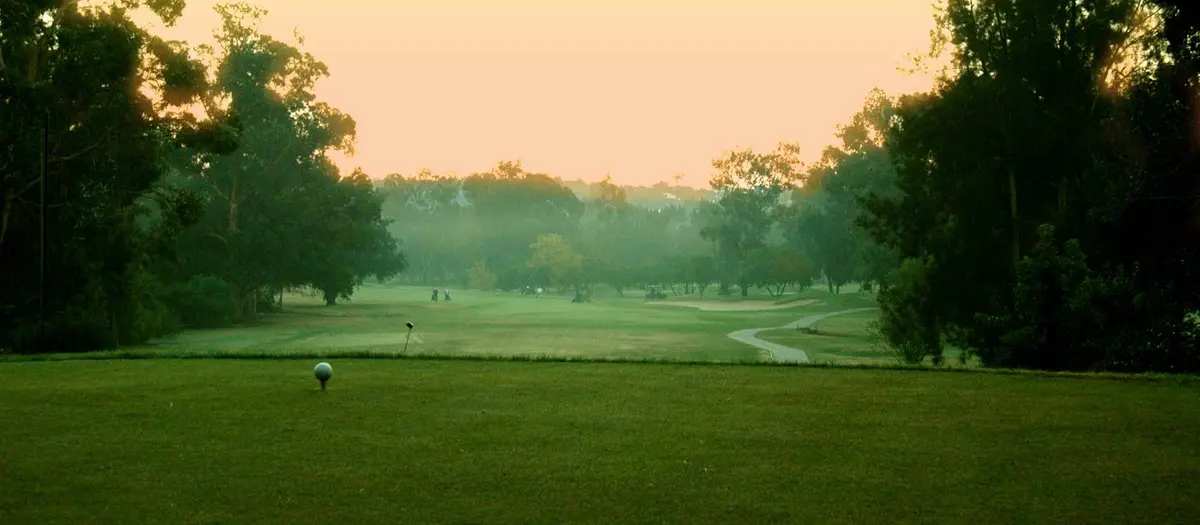 Sunset over a tree-lined fairway at Penina’s Sir Henry Cotton Championship Course