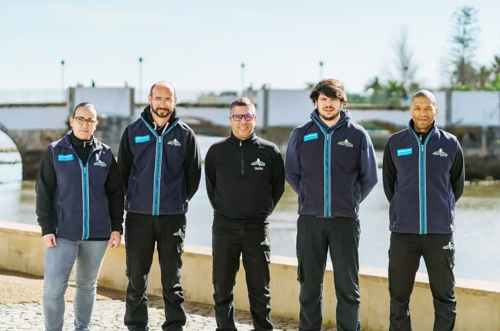 Members of the Abílio Bikes team wearing branded jackets