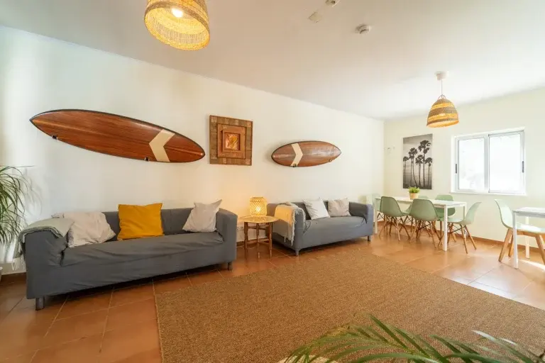 Sofas and wooden surfboards in the Aljezur Surf School surfhouse