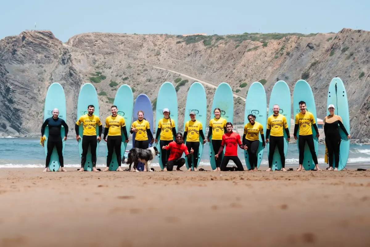 Arrifana Surf School instructors and students standing with boards on the beach