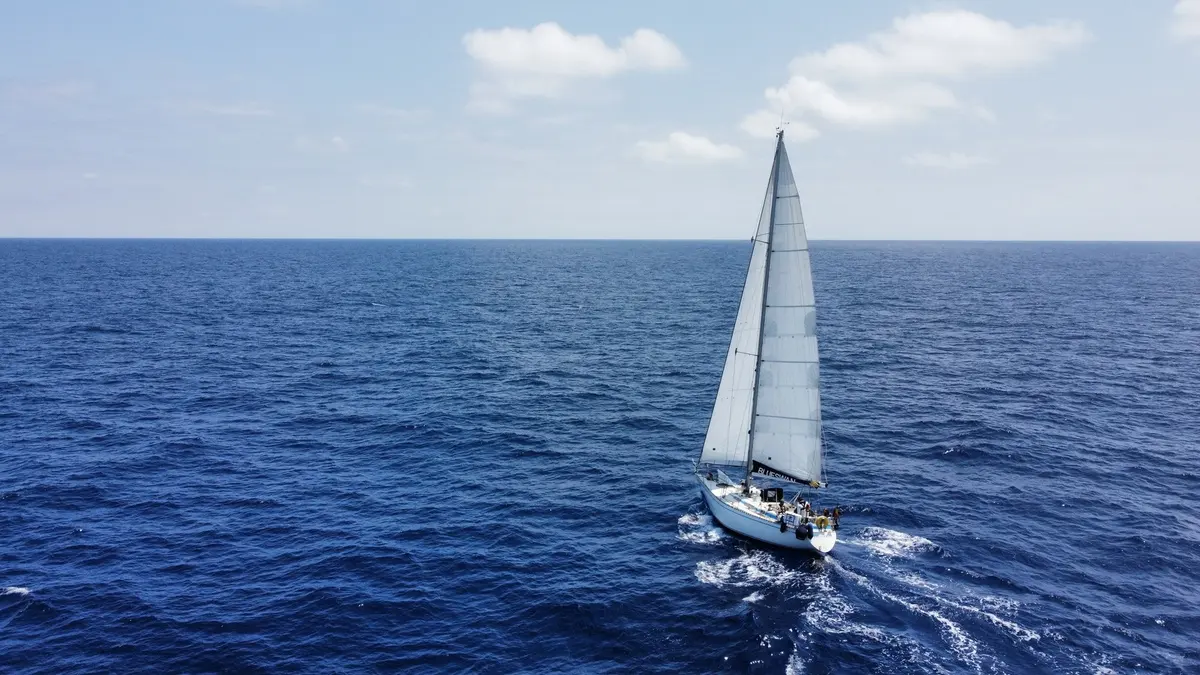 An overhead view of a sailing yacht at sea from Algarve Cruising Center’s programme