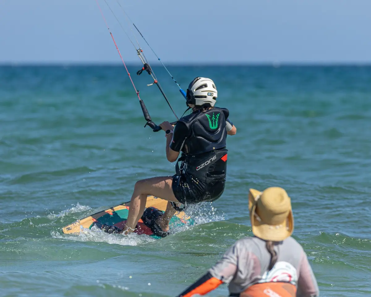 A kiteboarder practises beside an instructor in Eolis’s kitesurf lesson photograph