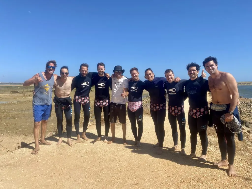 A group in wetsuits beside the lagoon in Lagos Kite Club’s school gallery