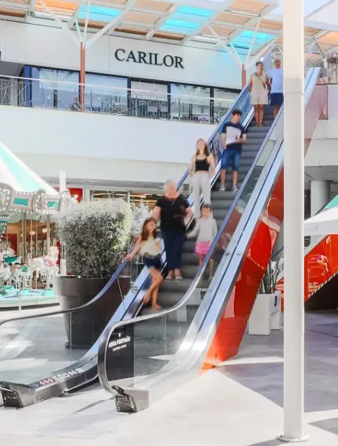Shoppers and escalators beneath the canopy at Aqua Portimão